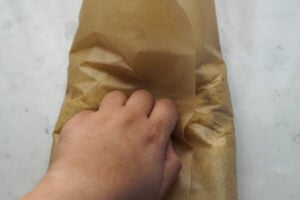 Kneading mixture in wax paper.