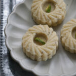 Ricotta cheese peda on a fluted white plate.