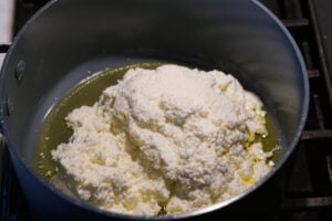 Ricotta and ghee in a non-stick pan.