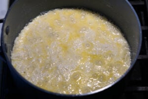 Ricotta cheese peda mixture simmering stovetop.