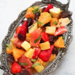 Fruit chaat in a silver ornate platter.