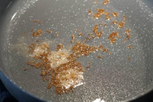 Cumin seeds and hing in oil in a non-stick pan.
