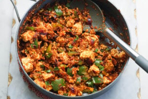 Paneer sabzi ready in pan with a serving spoon in pan.