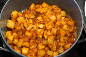Crushed tomatoes aadded to pan and mixed.