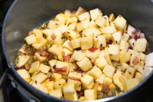 Turnips and spices mixed in pan.