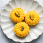 Three mango pedas in a fluted white plate.