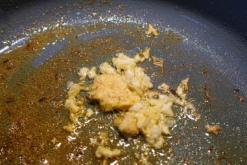 Crushed garlic and ginger added to tadka.
