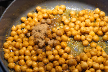 Chaat masala added to chickpeas.