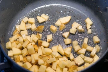Potatoes added to pan.