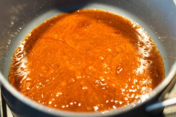 Melted jaggery and ghee in a pan.