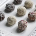 Coconut ladoos on a white tray.