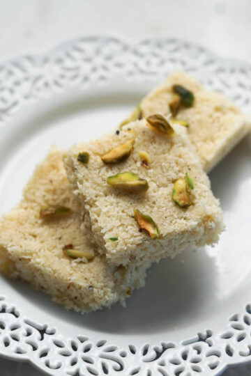 Kopra pak pieces on a white laced plate.
