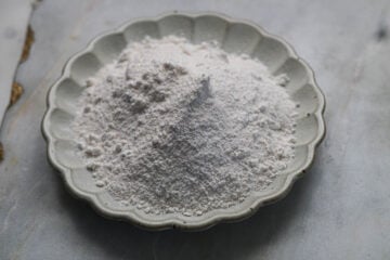 Ground granulated sugar on a white plate.