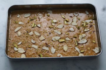 Magas mixture spread in pan and topped with nuts.