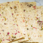 Bombay ice halwa sheets on countertop.