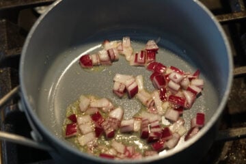 Red onions and oil in a pot.