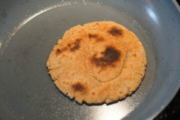 A bhakri on a pan stove top.