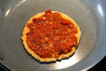 Bhakri with pizza sauce on it.