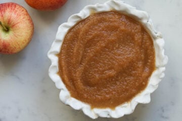 Indian style apple chutney in a white bowl.