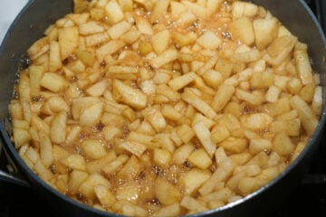 Apples simmering in a pan stove top.