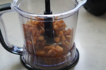Cooked apples for apple chutney in a blender jar.