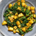 Methi aloo on a gray plate.