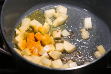 Potatoes and spiceds added to pan.