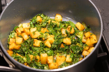 Aloo methi cooked in a pot.