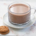 Chocolate chai (tea) in a mug with cookies to the side.