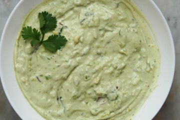 Avocado raita in a white bowl.