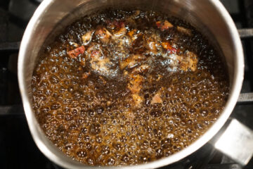 Rose chai simmering in a pot.