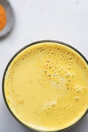 Haldi doodh in a glass.