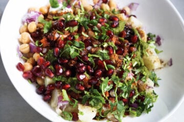 Aloo chana chaat ingredients in a white bowl.