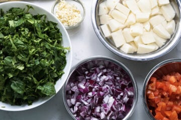 Chopped vegetables in bowls.