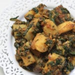 Aloo palak in a white laced plate.