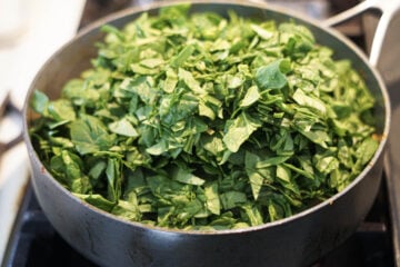 Chopped spinach added to pan.