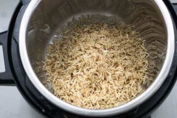 Rice and ghee in Instant Pot.