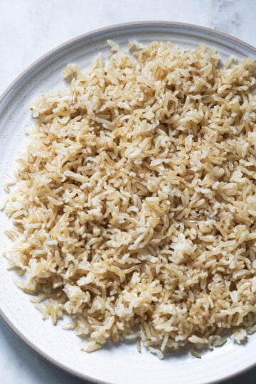 Fluffy brown basmati rice in a white plate.