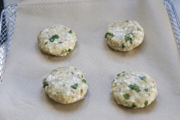 Sabudana vada brushed with oil on a tray.