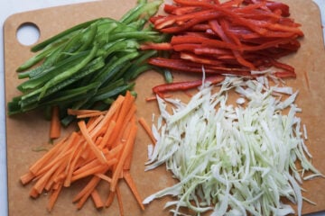 Julienned vegetables on a cutting board.