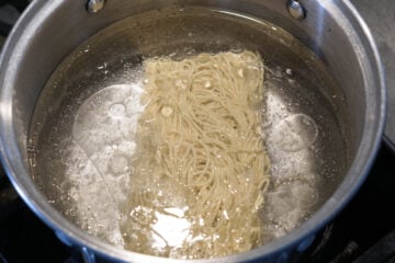 Hakka noodles in boiling pot of water.