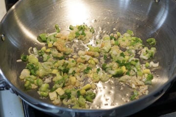 Spring onion whites and greens added to pan.