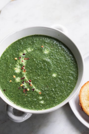 Spinach soup with red chili flakes.