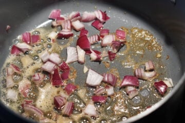 Red onions added to pan.
