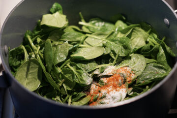 Spinach and spices in a pot.
