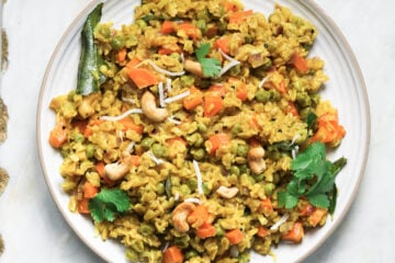 Oats upma in a white plate.
