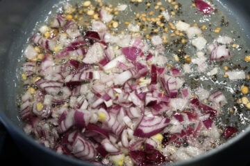 Red onions added to pot.