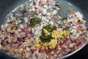 Green chili paste and ginger paste added to pot.