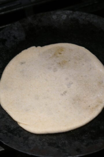 Raw puran poli disc on stove top.