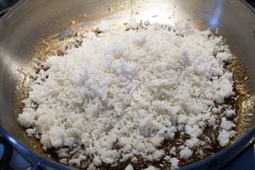 Sona masoori rice added to jaggery and spice tamarind sauce.